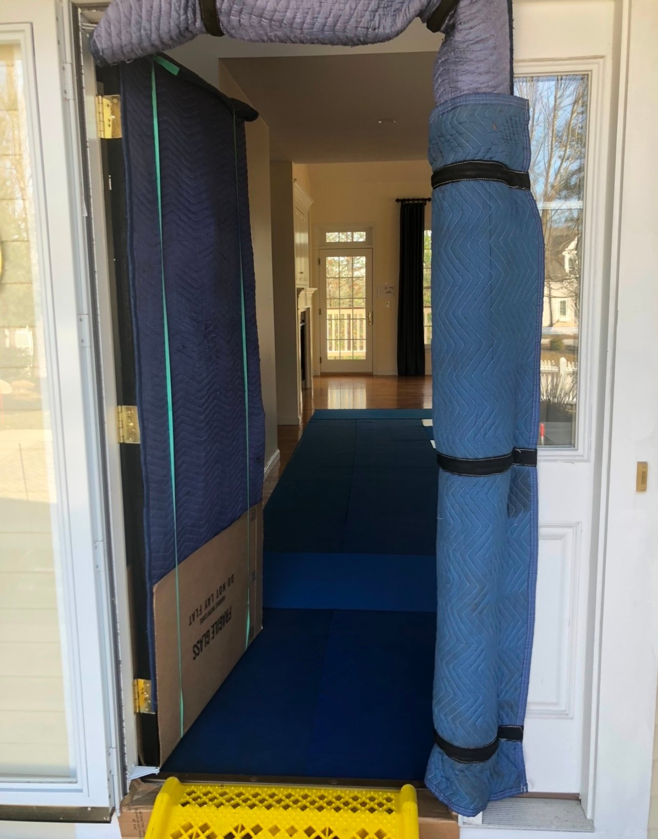 Doorway, trim and entry path protected with moving pads and floor runners
