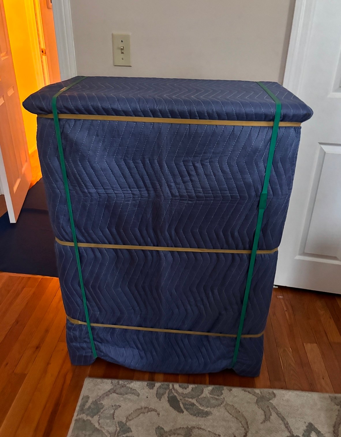 Furniture completely wrapped in moving pads and secured with bands